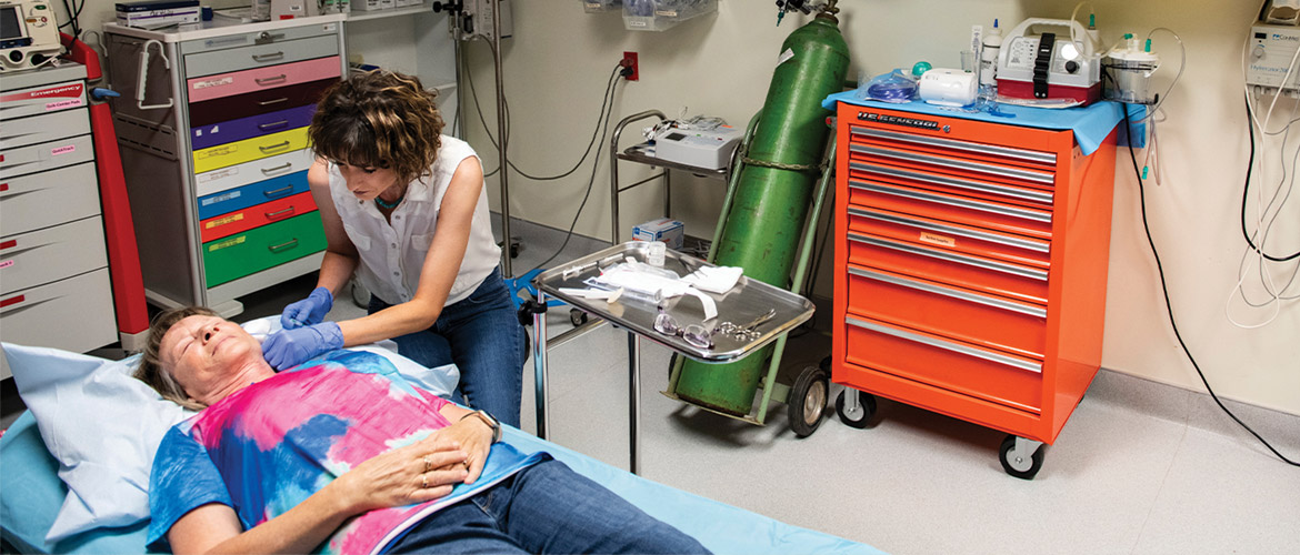 A nurse practitioner treats a patient